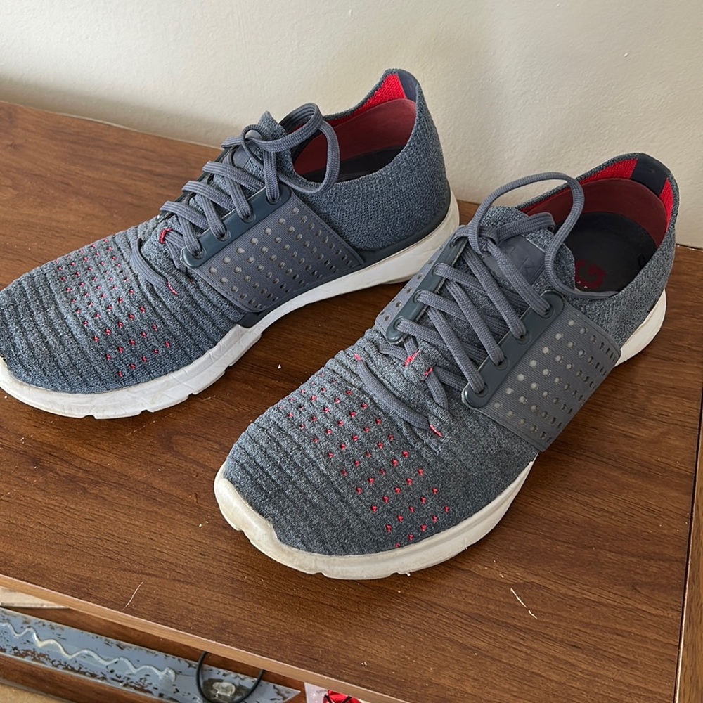 Gray and pink under armor running shoes